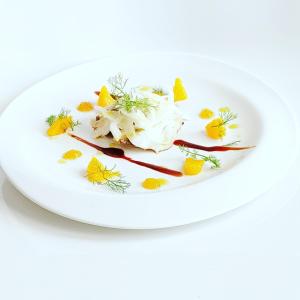 a white plate filled with food on top of a table at Villa Sant'Angelo in Alba Adriatica