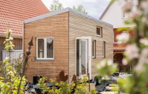 a tiny house sits in a garden at Gästehaus 26/2 in Bad Urach