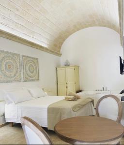 a bedroom with a bed and a table and a tub at Sweet Home Suite in Fasano +82 photos