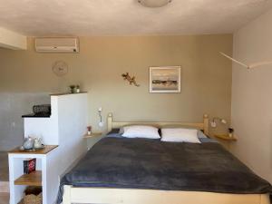 a bedroom with a large bed in a room at Vila Sunce Vis in Vis