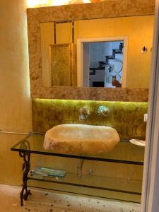 a bathroom with a sink and a mirror at Palazzo Salapolis - Luxury Apartments in Gallipoli