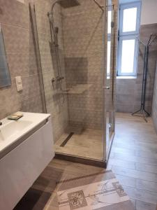 a bathroom with a shower and a sink at Sleep Well in Poznań