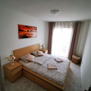 a bedroom with a bed and a large window at Andy apartman, Santa Pola in Santa Pola