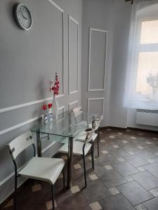 a dining room with a glass table and chairs at Sleep Well in Poznań