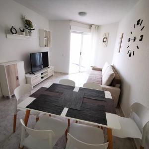 a living room with a table and a couch at Andy apartman, Santa Pola in Santa Pola