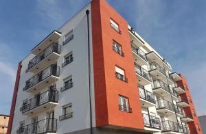 a tall building with balconies on the side of it at Apartman Sofija in Banja Koviljača