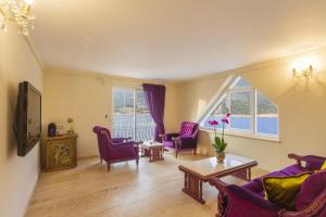 a living room with purple chairs and a table at Lukka Exclusive Hotel – Adult Only +12 in Kaş