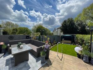 a small garden with a bench and a table at The Southbourne Villa in Torquay