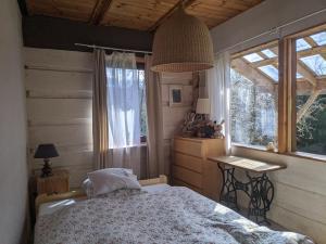 a bedroom with a bed and a table and a window at Pokoje u Agnieszki in Dwernik