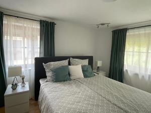 a bedroom with a large bed with green curtains at Ferienwohnung Siglreitmaier 2 in Chieming