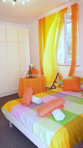 two beds in a room with orange and yellow curtains at Iva new room with private bathroom in Zadar