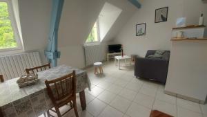 a living room with a table and a couch at Appartement ESTAUBE Résidence les 3 cirques in Gèdre