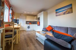a living room with a couch and a table at Suil Na Mara Studio in Lochinver