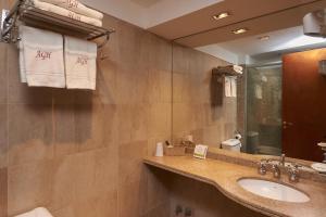 
a bathroom with two sinks and a mirror at Altos de Guemes Hotel in Mar del Plata
