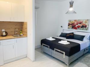 a small bedroom with a bed and a kitchen at Villa Franko Baška Voda in Baška Voda