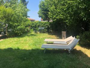a bench sitting in the grass in a yard at PeschieraView DUPLEX x7 in Peschiera del Garda