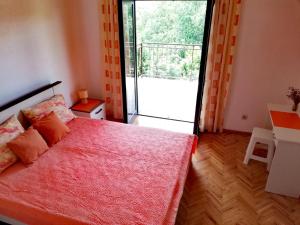 a bedroom with a bed and a sliding glass door at Apartment Marina in Malinska
