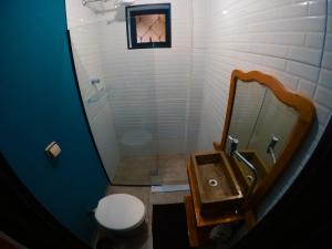 a bathroom with a sink and a toilet and a mirror at Pousada da Estação in Brotas +23 photos