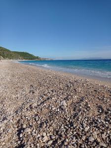 a rocky beach with the ocean in the background at Wave n' Sea Apartments in Himare