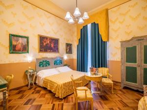 um quarto com uma cama, uma mesa e cadeiras em Hotel La Rosetta em Perugia