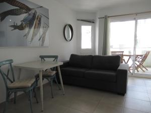 a living room with a couch and a table at La Rosita Sun Apartments, by Comfortable Luxury in Corralejo