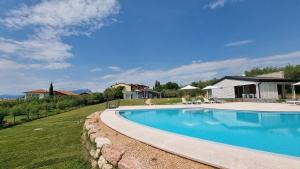 a swimming pool in a yard next to a house at Relais del Garda in Lazise