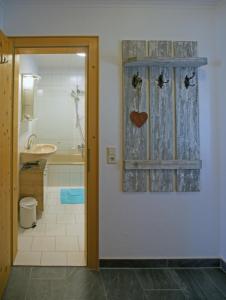 a bathroom with a door with a heart on the wall at Ferienwohnung Maria in Ebbs