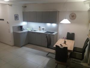 una piccola cucina con un tavolo e un lavandino di Haus Möltner - Apartment 1927 a Caldaro