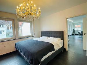 a bedroom with a large bed and a chandelier at apartment11 in Ulm