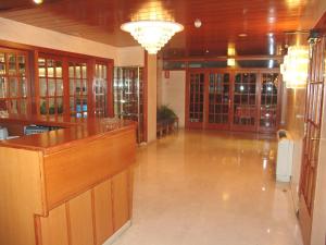 a large lobby with a bar in a building at Hotel Folch in Sant Julià de Lòria