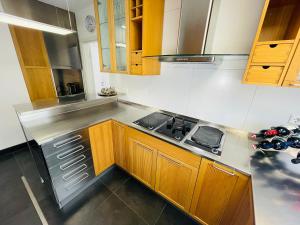 a kitchen with wooden cabinets and a stove at apartment11 in Ulm
