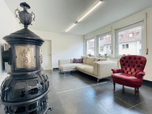 a living room with a fireplace and a red chair at apartment11 in Ulm