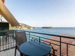 a table and chairs on a balcony overlooking the water at Marina in Kardamili