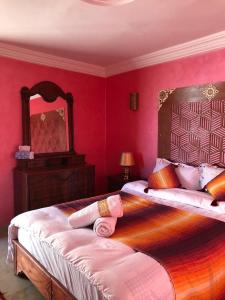 a bedroom with a large bed and a large mirror at Dar Rehab in Rabat