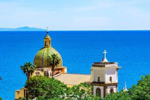 a church on top of a hill next to the ocean at La Nunziata in Positano