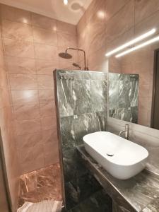 a bathroom with a sink and a glass shower at Latoura Studios in Ormos Panagias