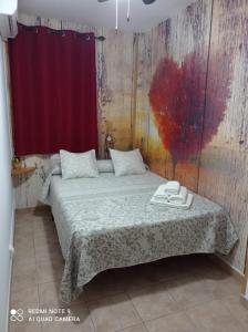 En eller flere senge i et værelse på Vivienda rodriguez