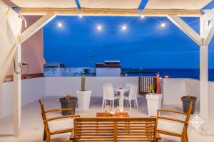 a dining room with a table and chairs at Almanzar - Residenze sul mare in Lampedusa +41 photos