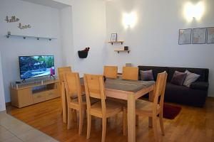 a dining room with a table and a couch at Apartmani Vila Karla, Dobropoljana, otok Pašman in Dobropoljana