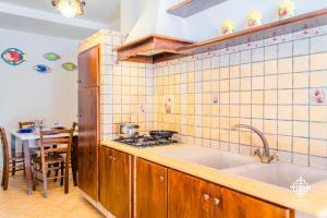 a kitchen with a sink and a stove at Almanzar - Residenze sul mare in Lampedusa