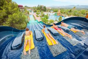 a group of children on a water slide at a water park at Vila LYDIA in Cambrils