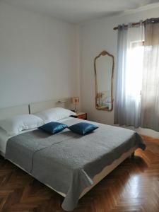 a bedroom with a bed with blue pillows and a mirror at Olive Garden Accomodation in Savar