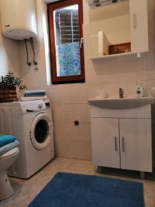a bathroom with a washing machine and a sink at Olive Garden Accomodation in Savar +20 photos