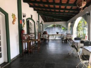 a dining room with a table and chairs at Pousada da Barra in Boicucanga