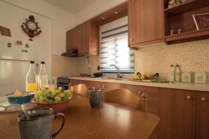 a kitchen with a wooden table with a bowl of fruit at Sunset Home Crete in Paránimfoi