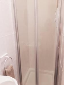 a shower with a glass door in a bathroom at The Cardoun in Blackpool