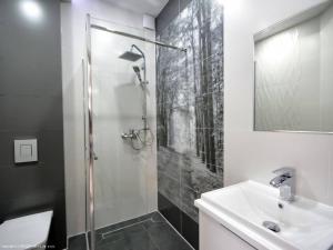 a bathroom with a shower and a sink at Platinium in Karwia