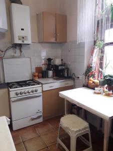 a kitchen with a stove and a counter with a table at Blue room. Lviv squre. in Kyiv
