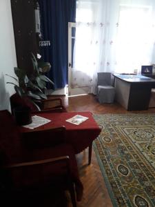 a living room with a table and a rug at Blue room. Lviv squre. in Kyiv