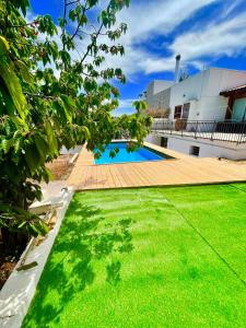 a backyard with a swimming pool and green grass at La casa di Colino e Annina in Monopoli